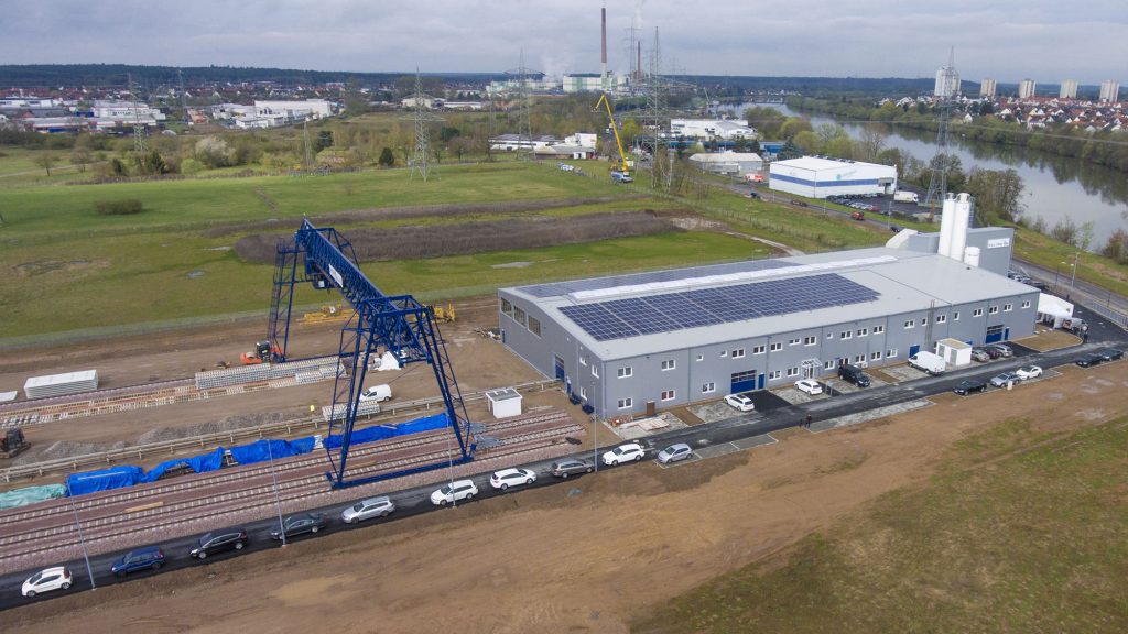 Luftbild: Produktionshalle mit Solardach und Portalkran
